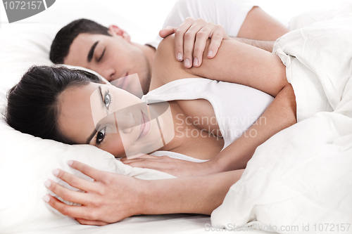 Image of Loving embracing lying couple of woman and sleeping man