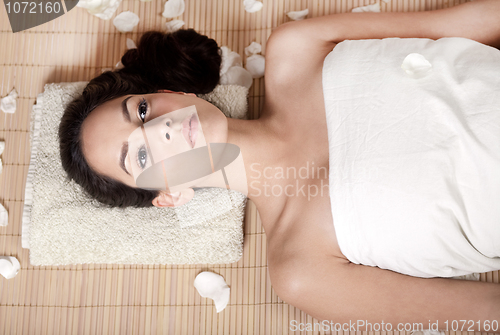 Image of Young woman relaxing and getting ready for spa treatment
