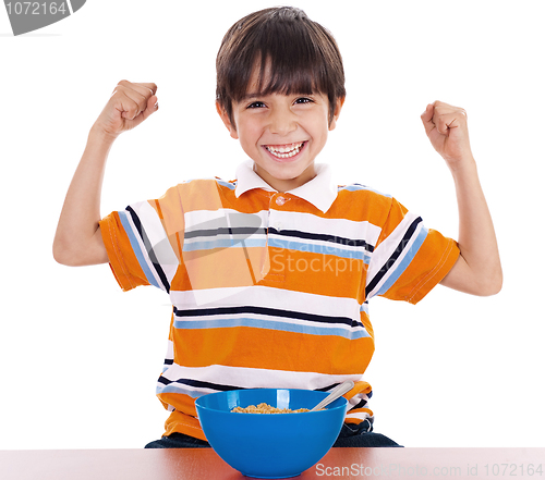 Image of Young boy shows his strength by raising his arms