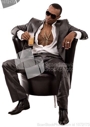 Image of Attractive young business man having a glass of juice in his hand