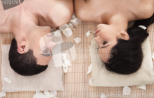 Image of Lovely couple looking eachother during spa treatment