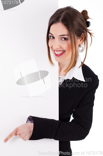 Image of Business women smiling and pointing a blank board