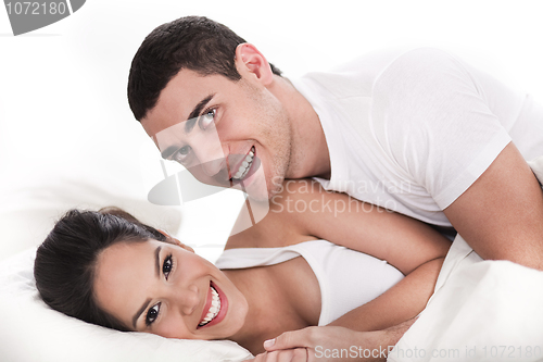 Image of Young couple having fun in bed