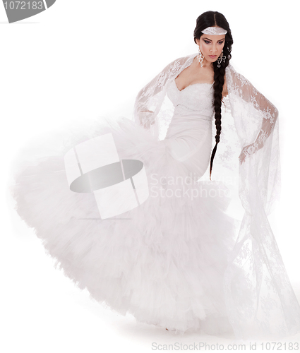 Image of Young brunette dancing bride in white gown