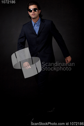 Image of young business man walking