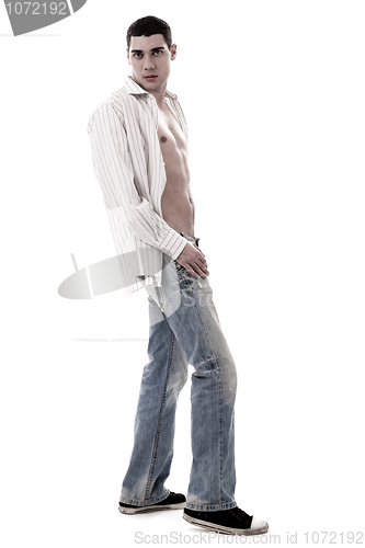 Image of A muscular model in a white open shirt and jean
