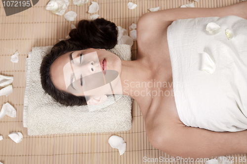 Image of Attractive woman getting flower spa treatment