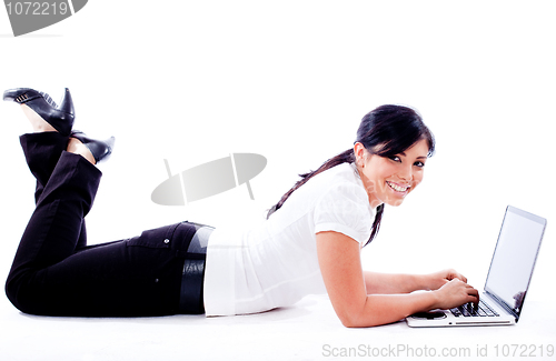 Image of Business woman lying with laptop