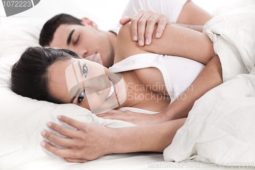 Image of Loving husband and wife lying in bed