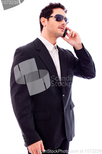 Image of Handsome young business man talking on phone