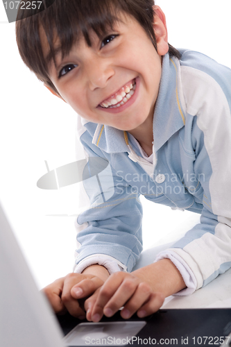 Image of Portrait of cute caucasian boy smiling with laptop