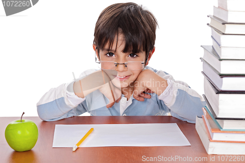 Image of Studying young boy gives strange look wearing specs