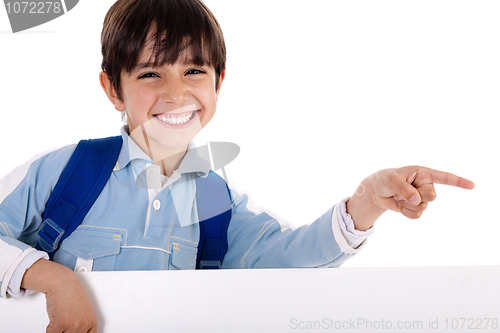 Image of Happy young boy pointing to copy sapce