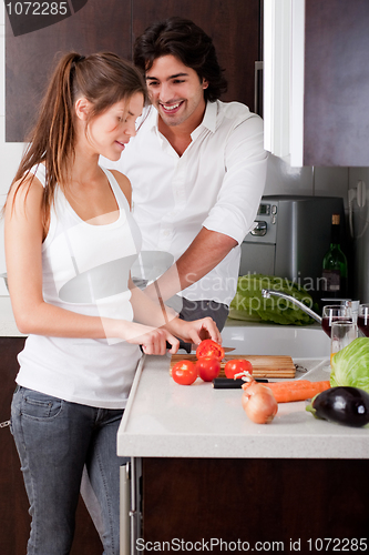 Image of woman sliceing tomatoes with her boyfriend