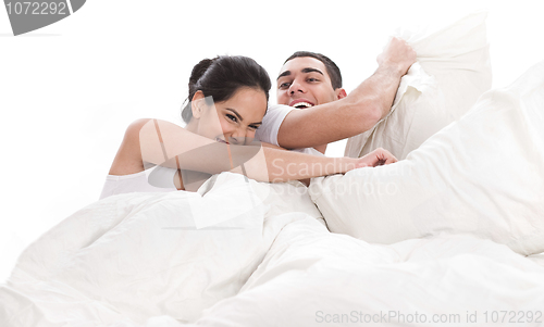 Image of Playful young beautiful couple with pillows