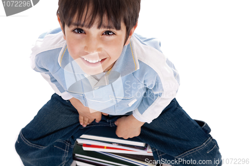 Image of Top angle image of kid sitting on books