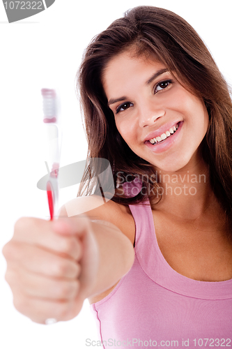 Image of beautiful young woman holding toothbrush and smiling