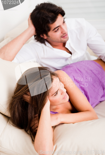 Image of romantic young couple lying in couch