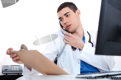 Image of Doctor convey his notes to others over phone