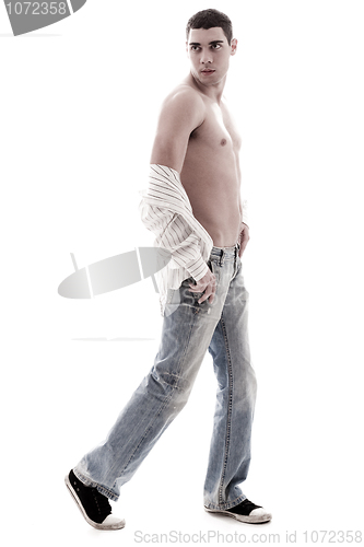 Image of Stylish model show his chest in open shirt and jean, side pose