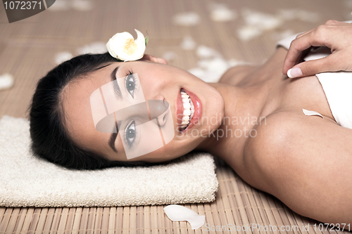 Image of bautiful smiling woman lying down for spa treatment