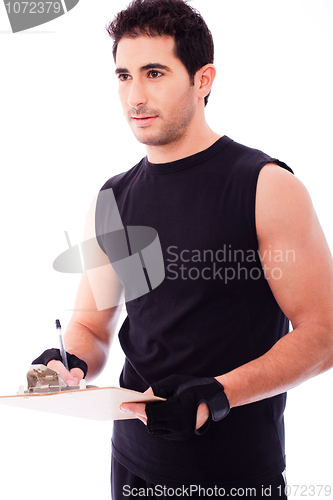Image of Fitness Trainer marking in a clip board