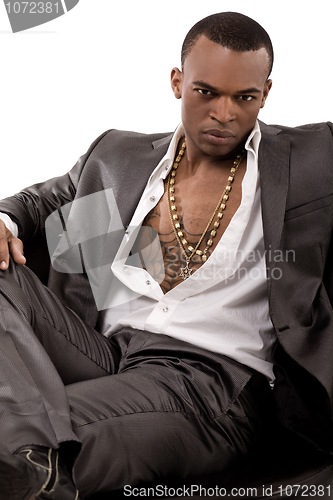 Image of Stylish young business man sitting on the couch