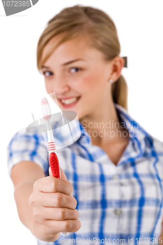 Image of Young women showing the toothbrush