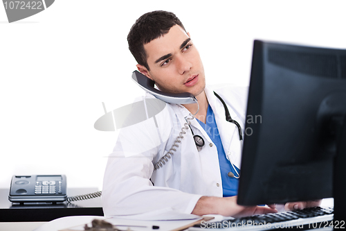 Image of Doctor logging his notes in computer