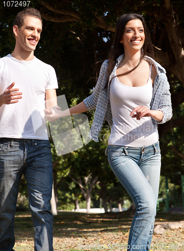 Image of Young couple running in the prak