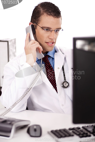Image of Male physician talking over phone