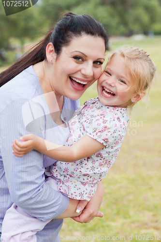 Image of Curious mother carrying her daughter with big smile