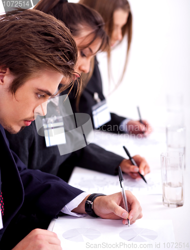 Image of business team taking notes