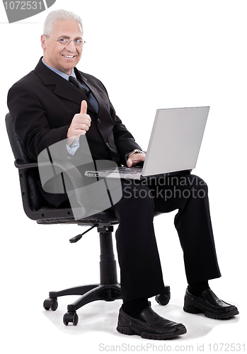 Image of Mature business man shows thumbs up on successful business