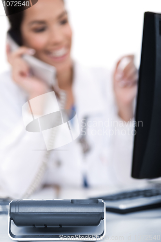 Image of Telephone of focus, doctor talking with it