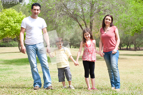 Image of Family posing to camera in the park