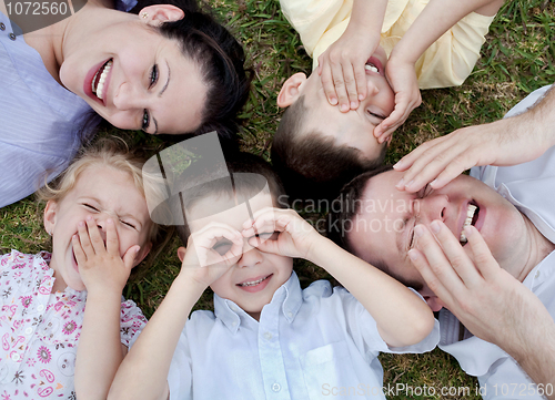 Image of Happy family lying in the ground