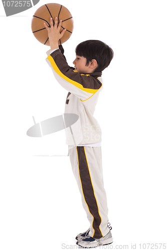 Image of Little kid while throwing the basketball
