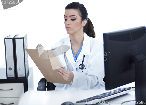 Image of Doctor woman sitting on her office making notes