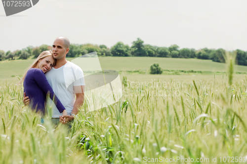 Image of Shot of young couple hugging and holding hands