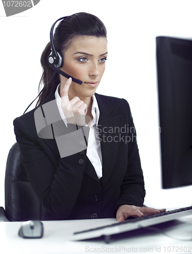 Image of Busy woman seriously hearing the customer talk in headset