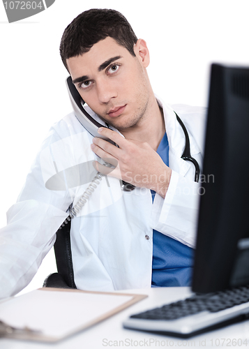Image of Male doctor speaking over telephone