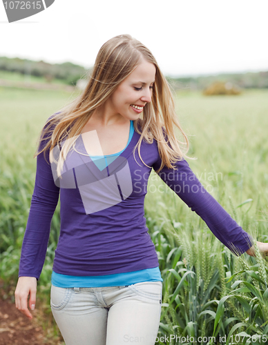 Image of Woman walking beside the field