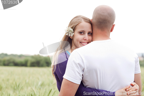 Image of Beautiful young lady hugging her husband