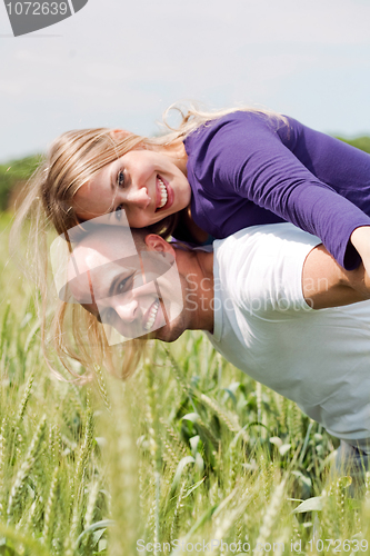 Image of Man giving his wife a piggyback ride