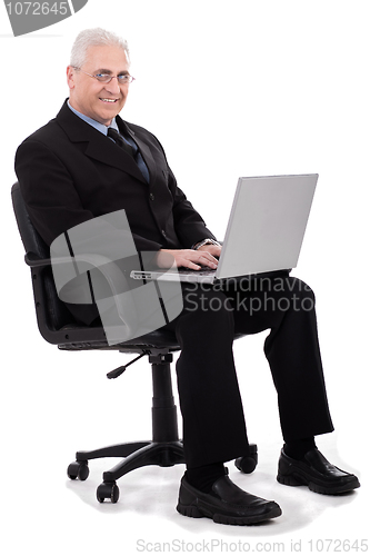 Image of Busy senior business man sitting in chair