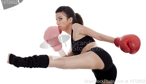 Image of Kickboxing girl giving strong kick with her leg