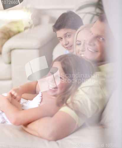 Image of Happy family smiling and looking  behind the window glass