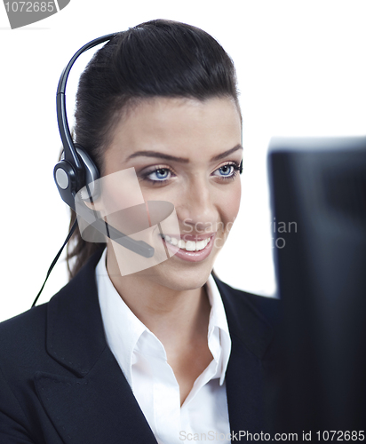 Image of Young blond business woman with headset closeup