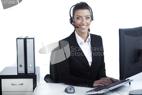 Image of Pretty business woman working at office wearing headset